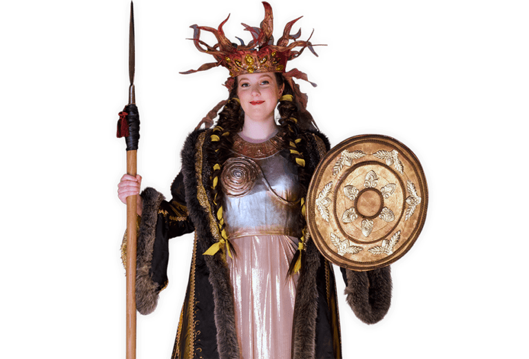 Viking queen Brita wearing an ornate crown and holding a shield and spear