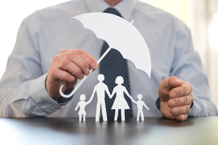 man with paper umbrella protecting family