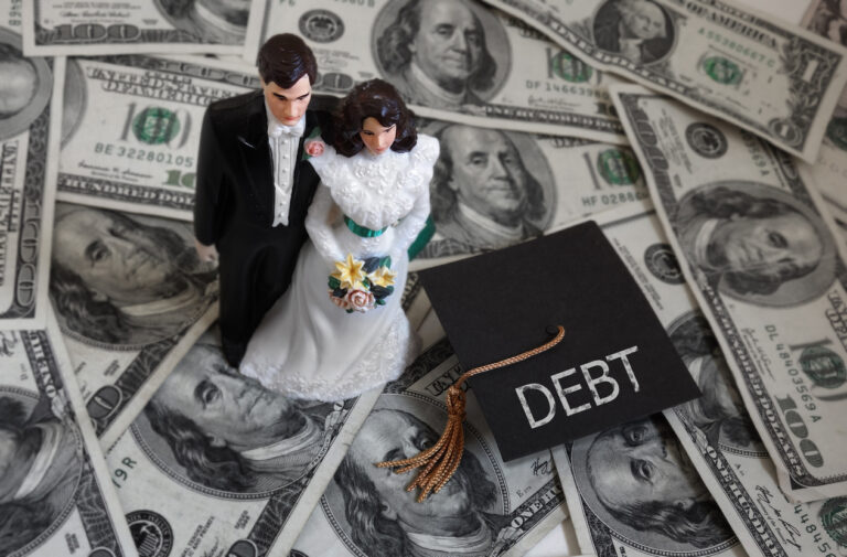 Newly married millennial couple on cash with student debt graduation cap