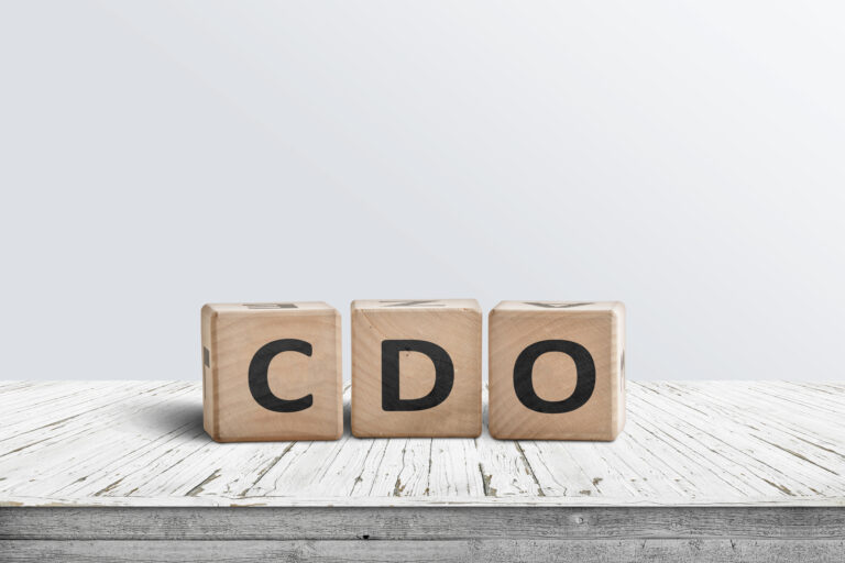 CDO sign collateralised debt obligations on a wooden desk