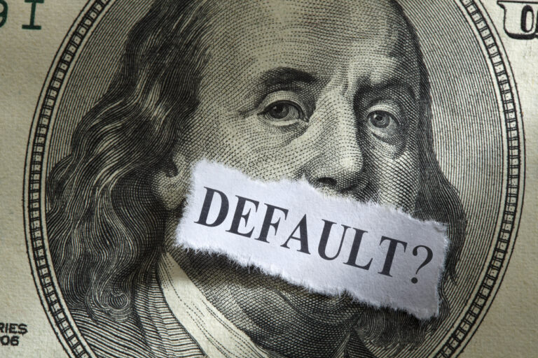 Image of $100 bill with paper saying "Default?"