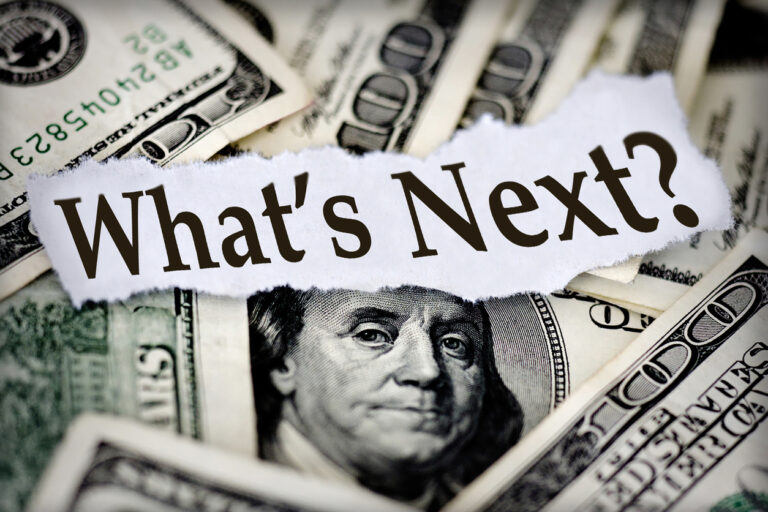 Image of "what's next" on paper in front of US currency