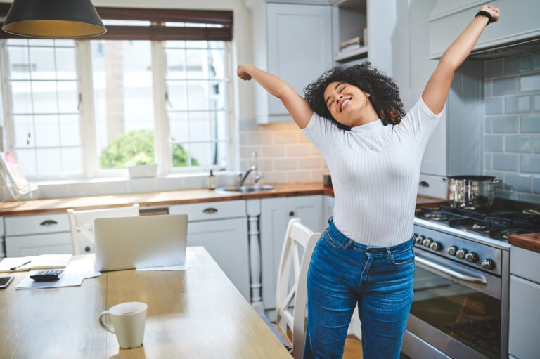 Image of woman jumping with joy after becoming debt free