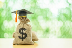 Image of money bag with graduation cap.