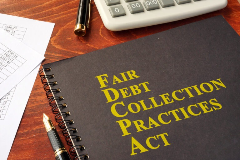 What can debt collectors do? FDCPA Fair Debt Collection Practices Act on a table.