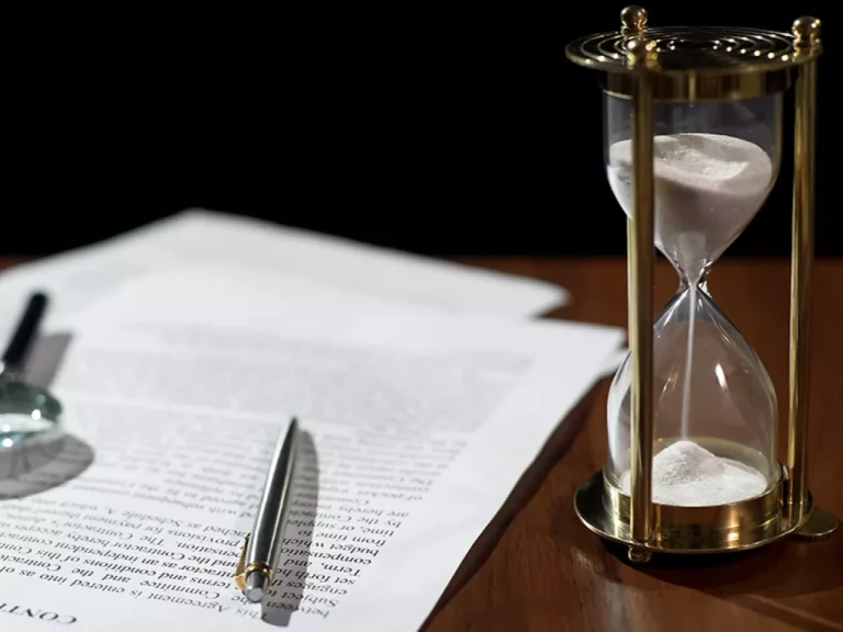 Image of paper and hourglass in legal setting