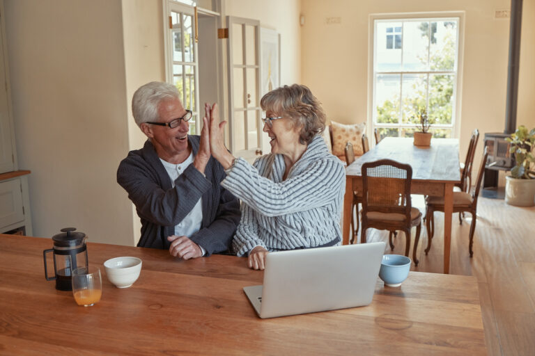 Couple celebrating becoming debt free with a high-five