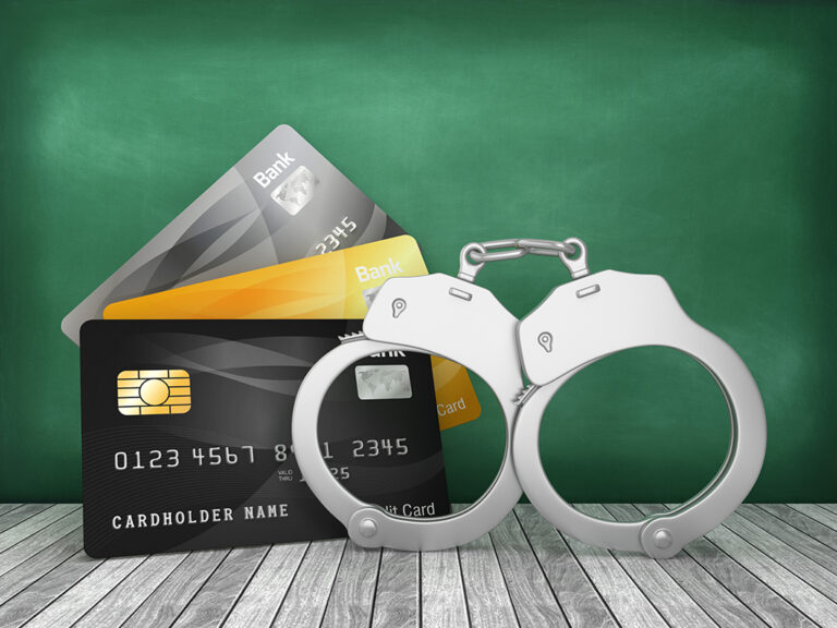 Credit Cards with Handcuffs on Chalkboard