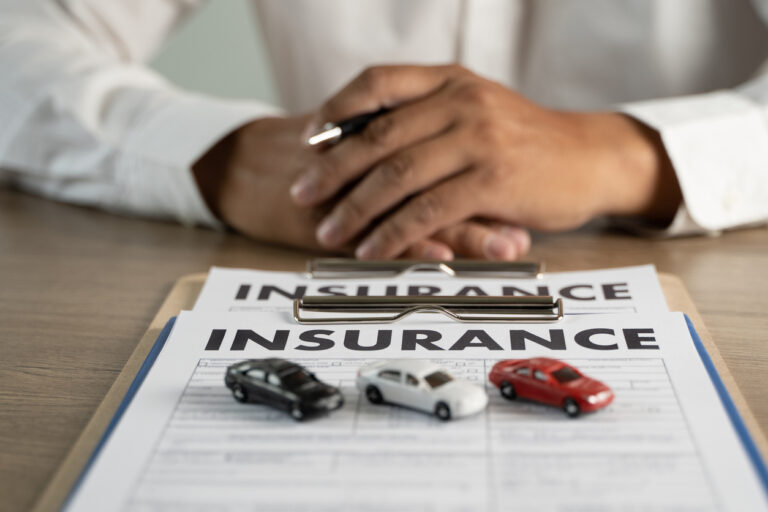 Man with car insurance deductible options on table