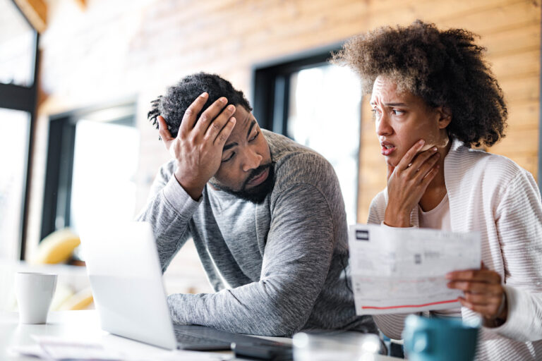 young couple at computer considering bankruptcy