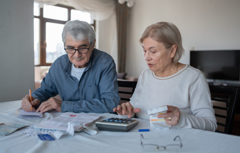 Senior Couple Calculating Budget Together