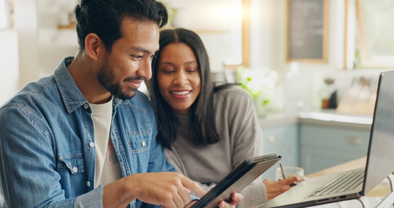 Couple looking at debt on tablet. Authorized Users.