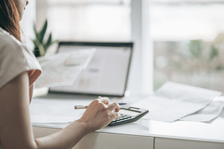 Woman calculating debt and checking debt report