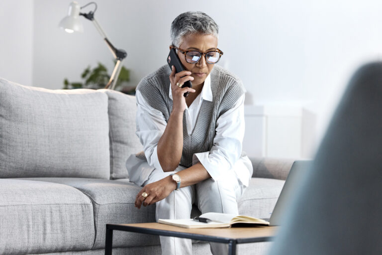 Woman on phone discussing life settlement options