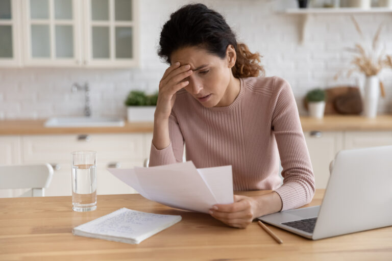 Woman stressed looking at medical bill