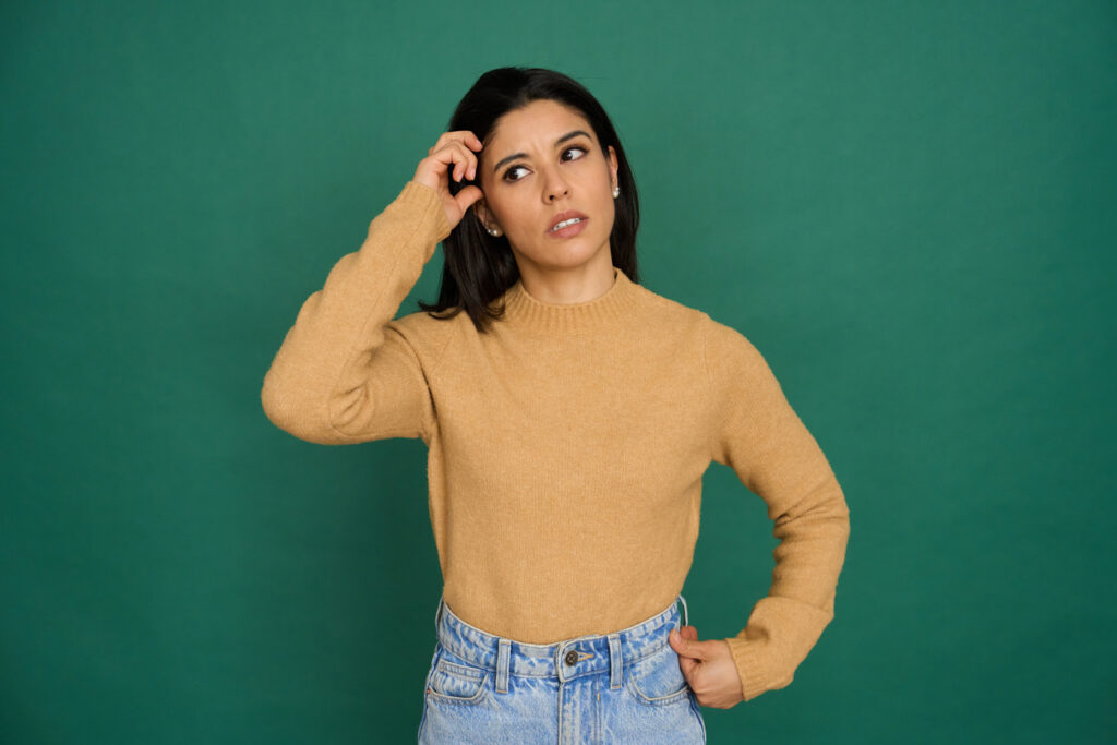 Woman scratching her head wondering about settling debt