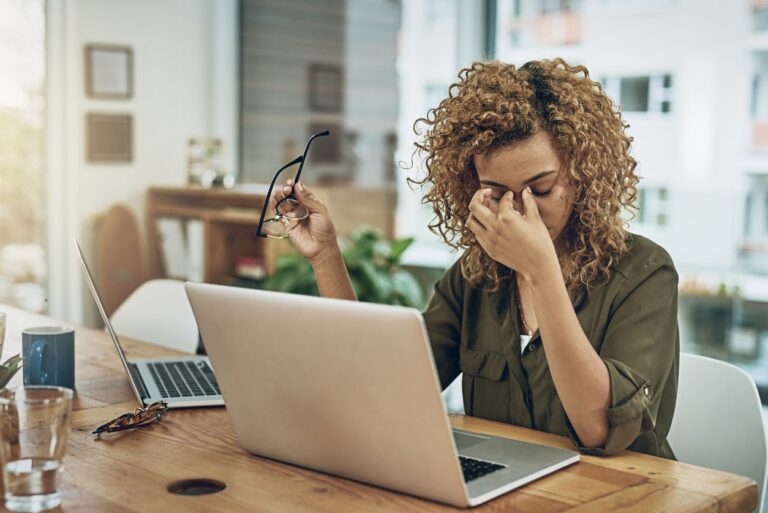 Young woman at home with headache from mold exposure