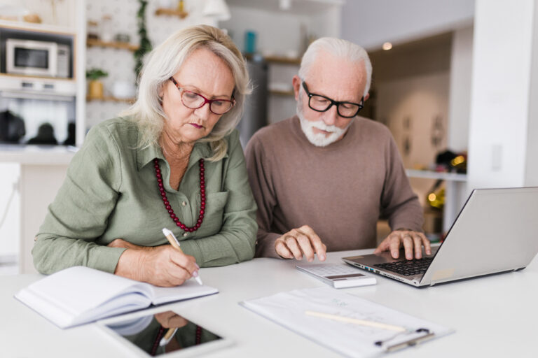 Senior couple using laptop while planning retirement