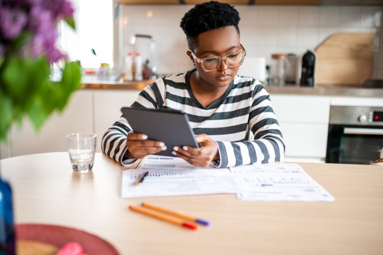 Young woman sitting at table looking at financial situation