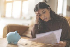 Woman stressing about a low checking account balance, wondering if it can go negative