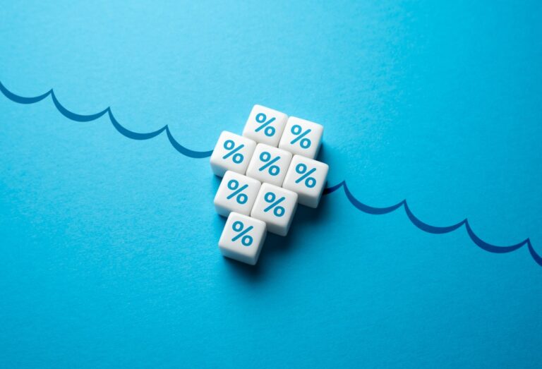 Dice with "%" printed on them, on a paper with waves - some dice underwater and some above