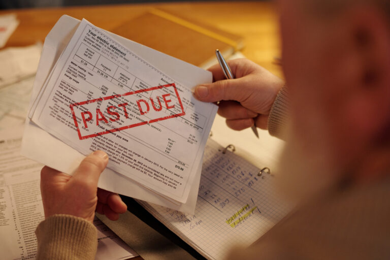 Hands of man with unpaid financial bill