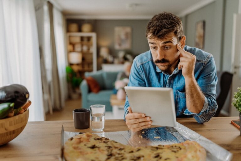 Man researching HEA requirements from tablet