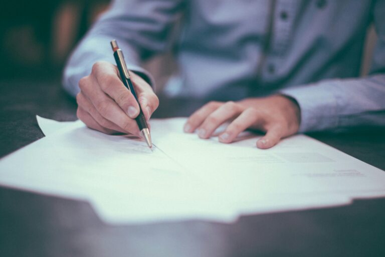 Man signing papers for lawsuit funding after car accident lawsuit