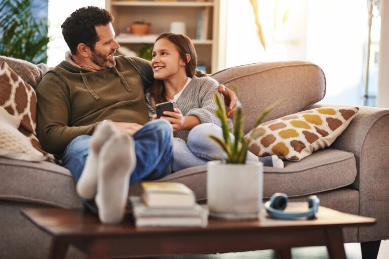 Dad with daughter on couch