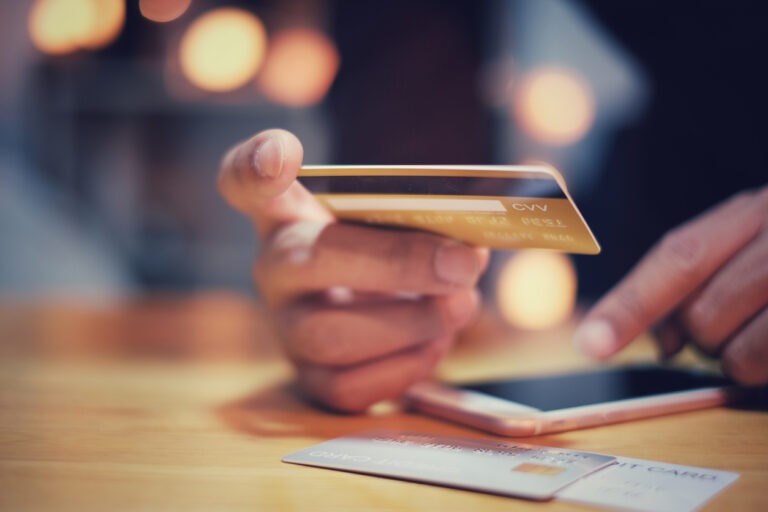 Man using credit card for online shopping payment with smartphone