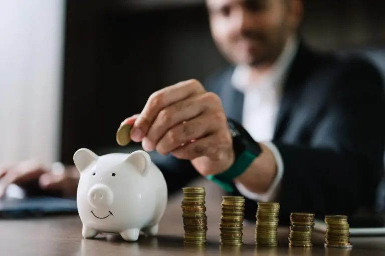 debt collector in suit putting coins in piggy bank